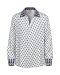White shirt with blue pattern on a beige background